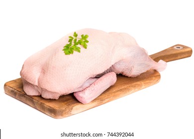 Raw duck on a wooden board on a white background