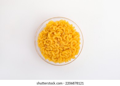 Raw Elbow Macaroni In A Clear Glass Bowl Shot From The Top