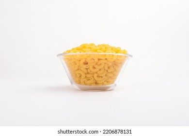 Raw Elbow Macaroni In A Clear Glass Bowl