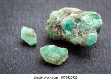 raw emerald gemstones (mineral beryl) with inclusions mined in Brazil on a gray slate stone - Shutterstock ID 1078420928