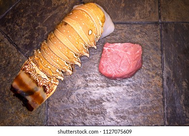 Raw Filet Mignon Steak And Lobster Tail For Surf And Turf On State Tabletop.