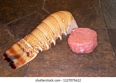 Raw Filet Mignon Steak And Lobster Tail For Surf And Turf On State Tabletop.