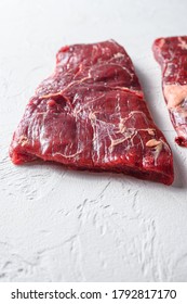 Raw Flap Meat, London Broil Organic Meat Cut Side View Close Up Over White Concrete Background Vertical Selective Focus