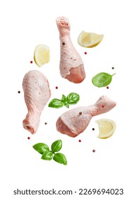 Raw flying chicken drumstick And spices cut out on a white background