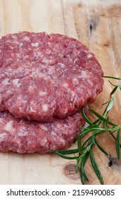 Raw Free Range 100% Beef Burger Patties On Mottled Grey With Copy Space