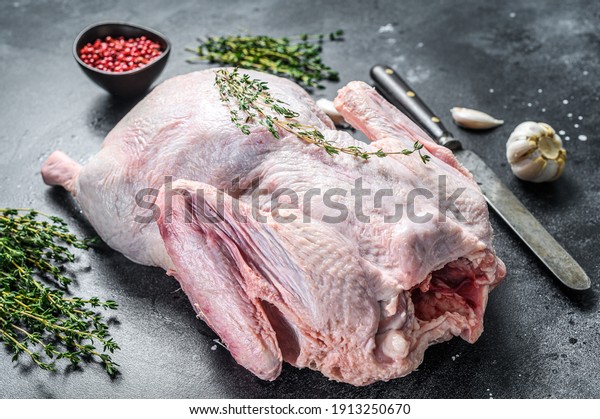 Raw free range duck with spices ready to cook. dark\
background. Top view