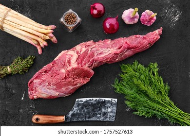 Raw fresh beef whole tenderloin with spice on black background