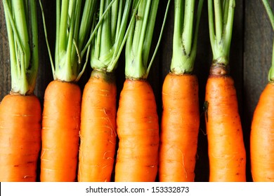raw fresh carrots with tails, top view