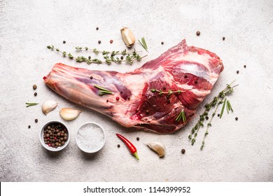 Raw fresh Lamb Meat shank and seasonings on gray concrete background