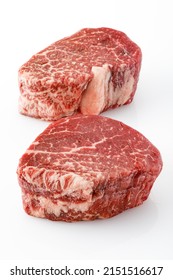 Raw fresh marbled filet mignon steak. Two meat pieces on white