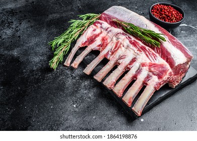 Raw fresh rack of lamb meat on marble board. Black background. Top view. Copy space. - Powered by Shutterstock