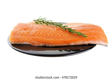 raw fresh uncooked salmon red fish fillet on black plate with rosemary twig isolated over white background - Shutterstock ID 478172029