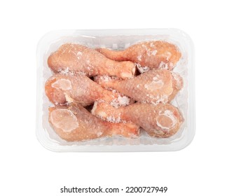 Raw frozen chicken drumsticks in a plastic container isolated. Fresh iced chicken legs, drumsticks on white background with clipping path top view - Shutterstock ID 2200727949