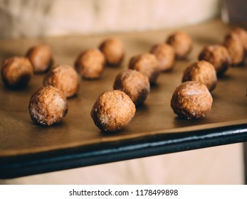 Raw Frozen Meat Balls On Baking Sheet With Paper.