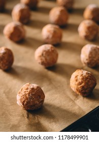 Raw Frozen Meat Balls On Baking Sheet With Paper.