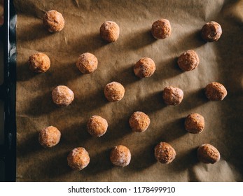 Raw Frozen Meat Balls On Baking Sheet With Paper.