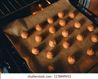 Raw Frozen Meat Balls On Baking Sheet With Paper.