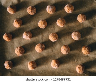 Raw Frozen Meat Balls On Baking Sheet With Paper.