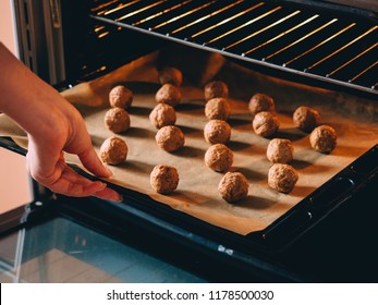 Raw Frozen Meat Balls On Baking Sheet With Paper.