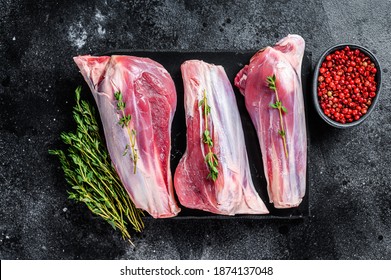 Raw Goat Shanks Meat On A Marble Board. Black Background. Top View