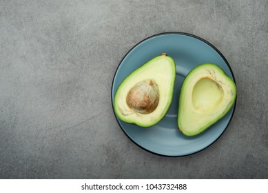 Raw green avocado on a stone table. Diet meal. Top view - Shutterstock ID 1043732488