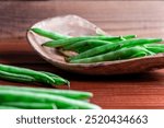 Raw green beans on wood background