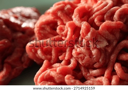 Raw Ground Beef Close-up. Minced Meat for Cooking. Detail of Fresh Red Meat. Raw ground beef with selective focus.Details of the raw ground beef, with slightly blurred background.