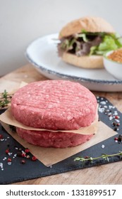 Raw Ground Premium Beef Burger Cutlets Homemade On Wooden Cutting Board With Salt And Pepper