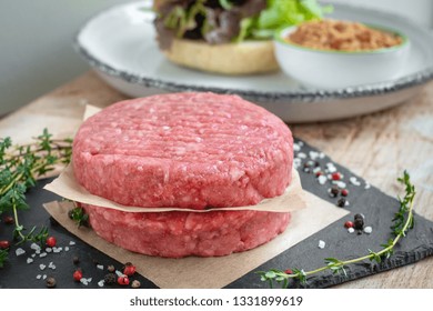 Raw Ground Premium Beef Burger Cutlets Homemade On Wooden Cutting Board With Salt And Pepper