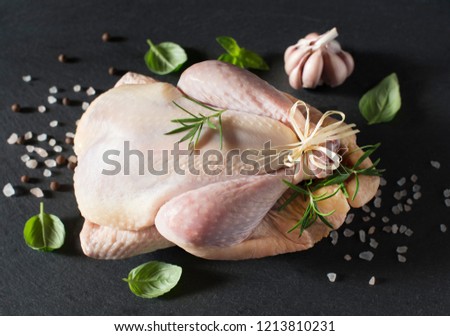 Raw guinea fowl on a black stone. Poultry dishes.