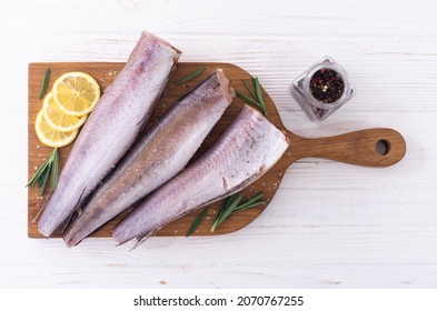 Raw Hake On Wooden Background . Ready To Cooking