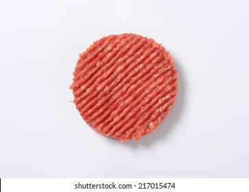 Raw Hamburger Patty On White Background