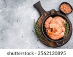 Raw Headless Red Argentine shrimps, Prawns in a skillet. grey background. top view.