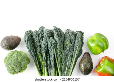Raw healthy food clean eating vegetables source of protein for vegetarians: broccoli, bellpepper, kale, tomato, avocado. Fresh colorful organic vegetables captured from above, top view, flat lay.