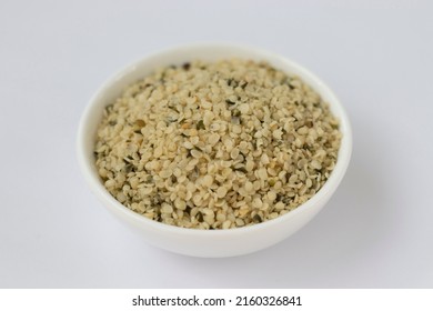 Raw Hemp Kernels In A Small Plate On A White Background. Omega 3