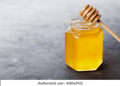 Raw Honey In A Jar On Black Table