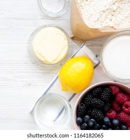 Raw Ingredients: Berries, Lemon, Flour, Sugar, Salt, Water For Cooking Berry Pie, Overhead View. From Above, Top View, Flat Lay. Close-up.