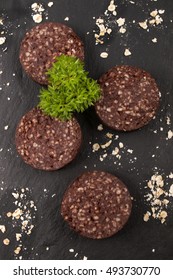 Raw Irish Black Pudding With Oatmeal And Parsley On Slate