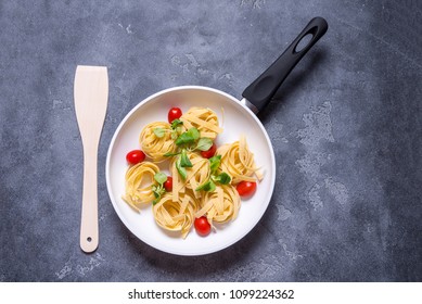 Raw Italian Pasta With Tomato In White Ceramic Pan