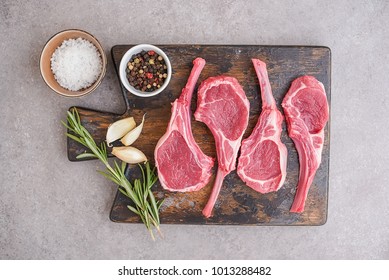 Raw lamb chops on stone background