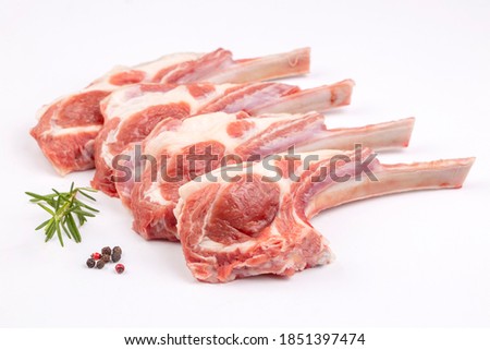 Raw lamb chops on a white background