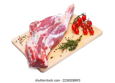 raw lamb leg with vegetables, loin on the bone with herbs, meat shoulder blade on a wooden cutting board, on a white isolated background - Powered by Shutterstock