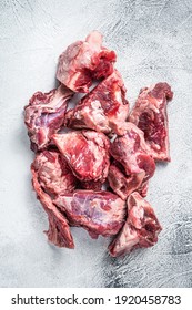 Raw lamb meat stew cuts with bone. White background. Top view