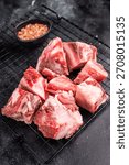 Raw lamb mutton meat and bones for stew or goulash. black background. top view.