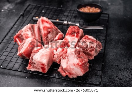 Raw lamb mutton meat and bones for stew or goulash. black background. top view.