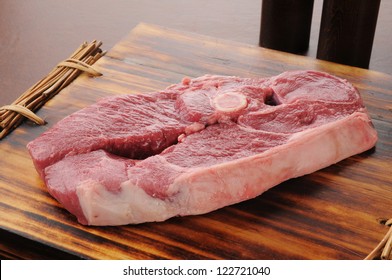 Raw Lamb Shoulder Chop On A Cutting Board