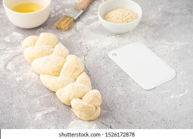 Raw loaf of challah Jewish bread on a light background. Copy space.