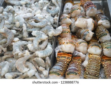 Raw Lobster Tail And Shrimp Frozen On The Ice For Sale