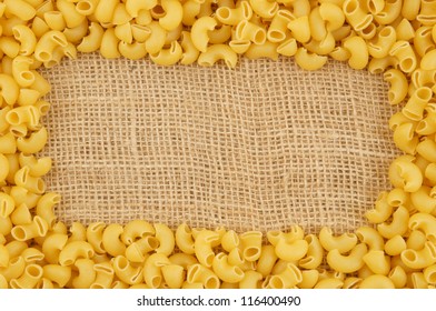 Raw Macaroni Frame On Sack Hessian Burlap Background