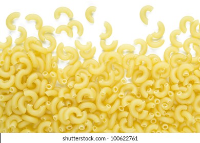 Raw Macaroni Noodles Spilled On White Background